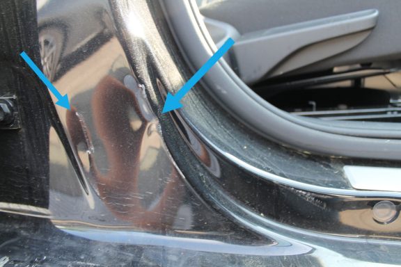 B-Säule Außenhaut eingedrückt bis auf Innenstrucktur Reflektierende Oberfläche am Fahrzeug mit zwei markierten Stellen.
